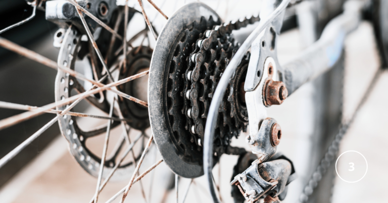 a close up of rear bike gears - the cassette that is slightly rusty