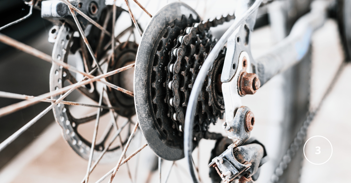 a close up of rear bike gears - the cassette that is slightly rusty
